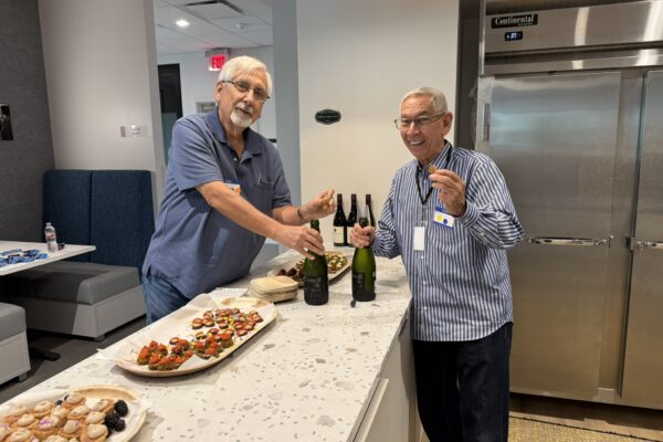 Board members Steven Paulson and Marvin Brittman prepare a toast celebrating a successful retreat!